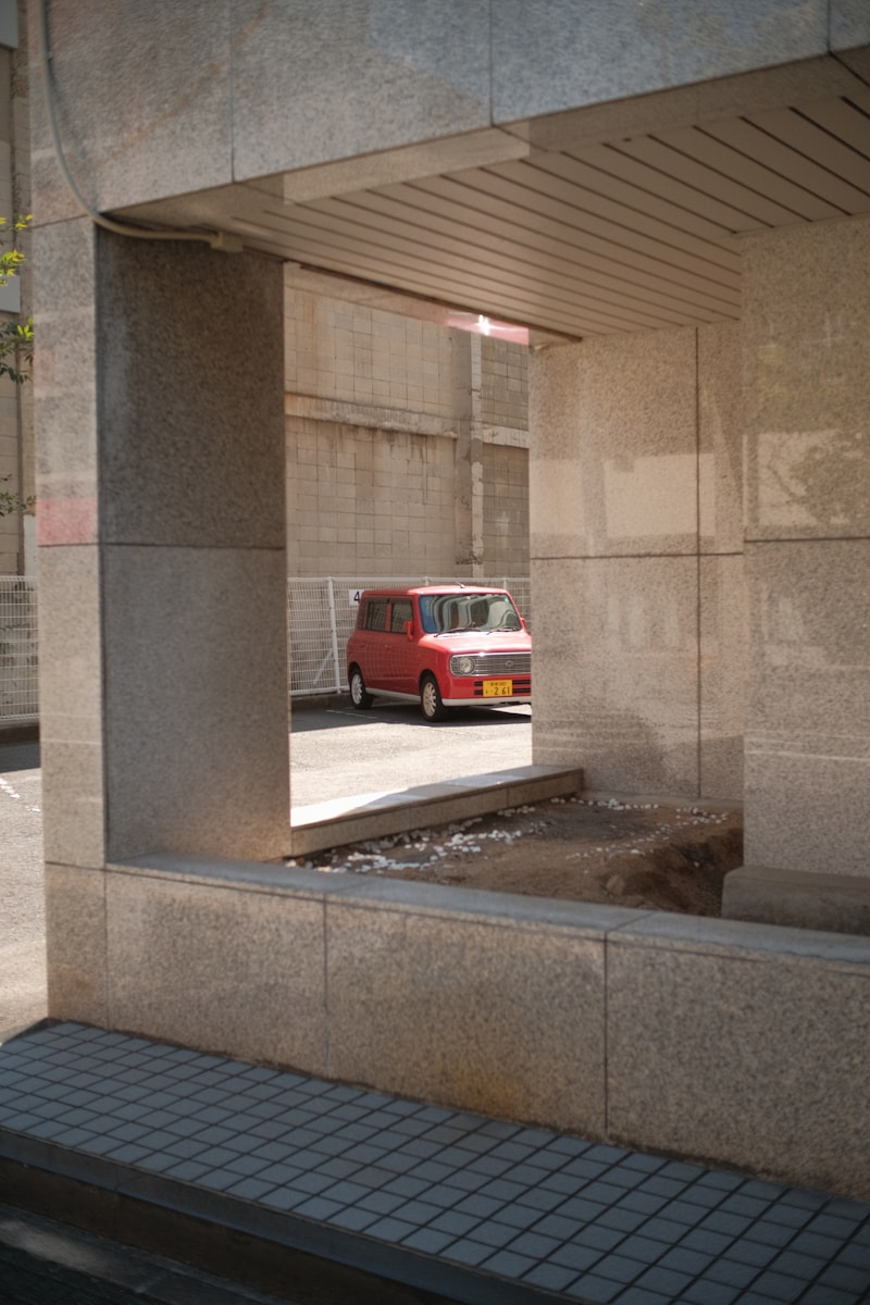 a red van is parked in a parking garage